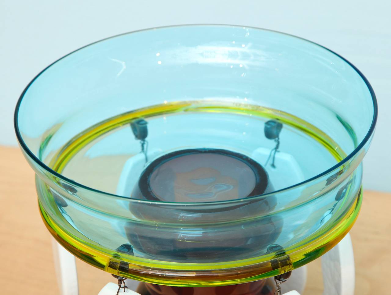 Rare footed bowl by Ettore Sottsass for Memphis. Turquoise and amethyst blown-glass sections with applied yellow glass trim and opaque white glass hanging elements. A playful design from Sottsass most prolific period. Etched signature along the