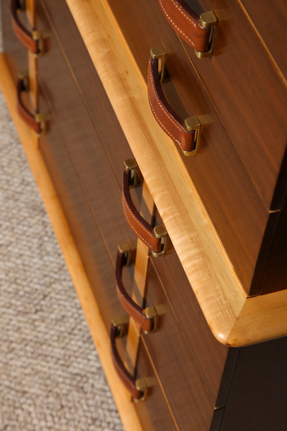 Six-drawer mahogany chest with pearwood trim. Firm leather pulls with top-stitching and brass mounts. A great form from an exceptional series that was produced by Johnson Furniture for a very short time.