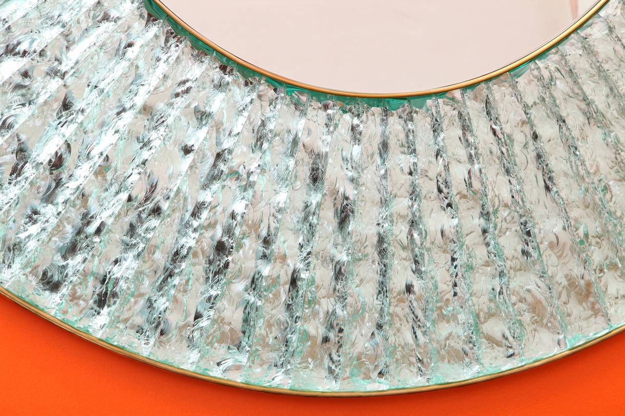 Large-Scale, Studio-Built Circular Mirror by Ghiró Studio. Clear crystal chunks that have been hand-cut, chipped and arranged around a central mirror. Brass mounts and artist signed. These mirrors are made to order and require 12-15 weeks lead time.