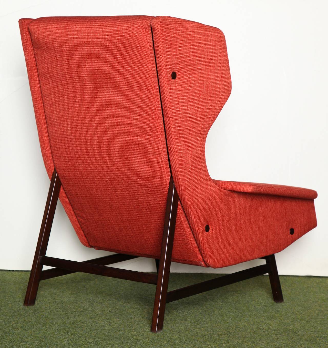 Great architectural lounge chair in dark wood base. Modernist wingback form with great details. The last image is a period ad from Rivista dell'Arredamento, Nov. 1961.