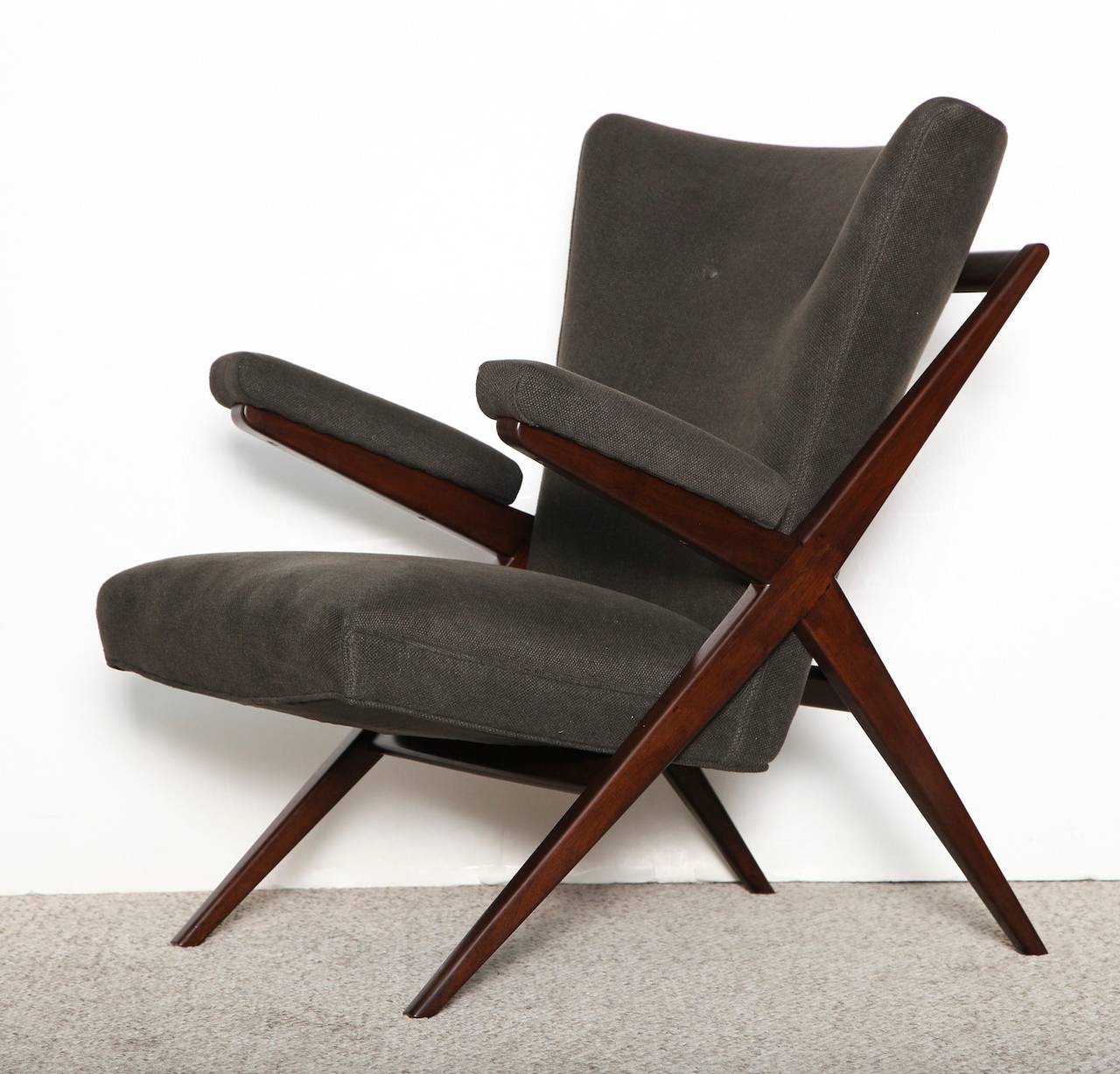 Dark stained walnut frames with upholstered seats and armrests. Great architectural X-forms. Designed in 1949, this model was in production throughout the 1950s. Produced and sold by Cassina in Italy and distributed in the USA by M. Singer & Sons.