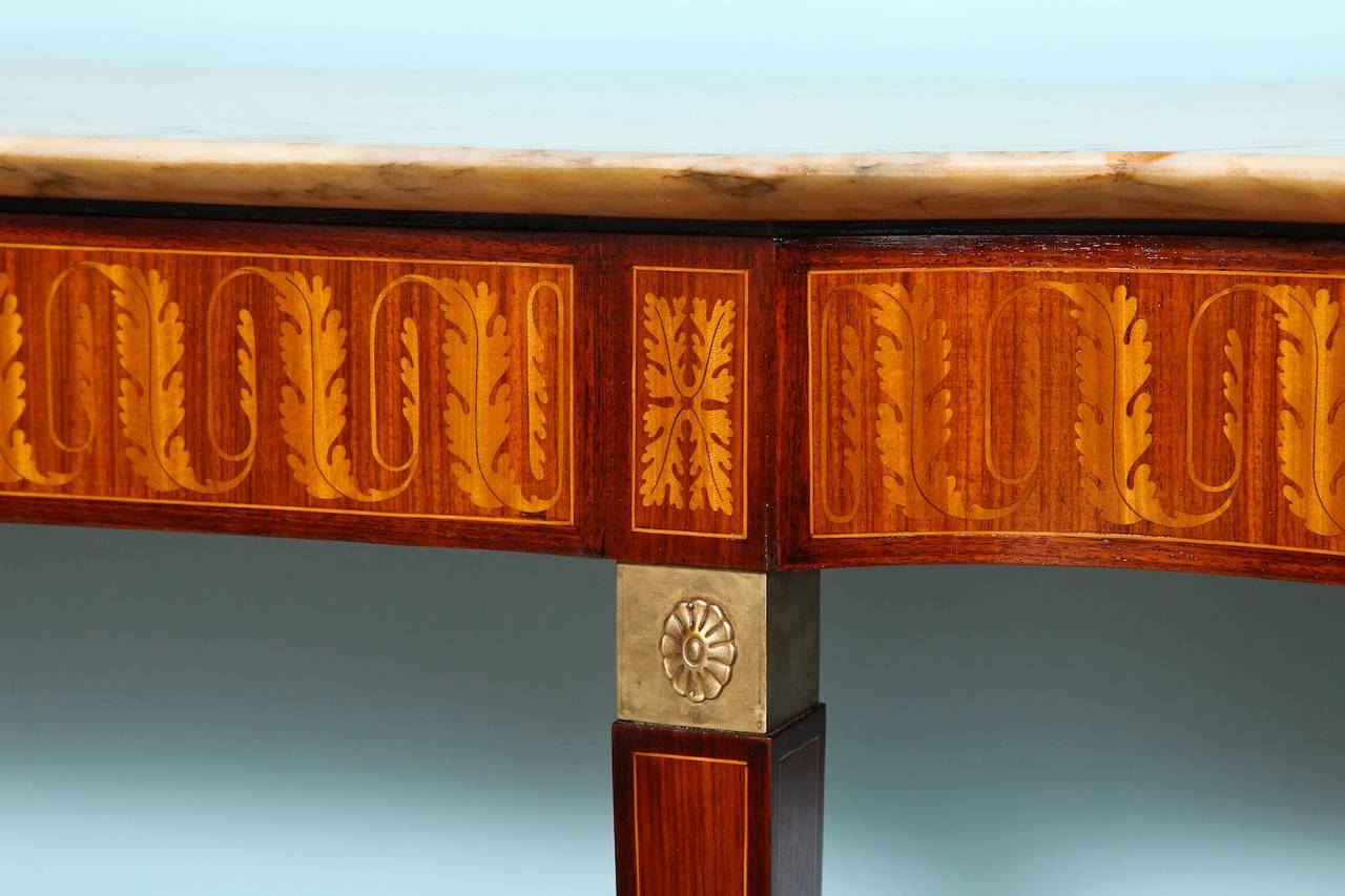 Rosewood & mahogany console on 6 tall, tapering legs.  Inlaid foliage throughout upper section by Giovanni Garibaldi,  Inlays & medallions on wood legs.  Brass feet and mounts.  Pale onyx top sculpted to match the lines of the console.  A beautiful