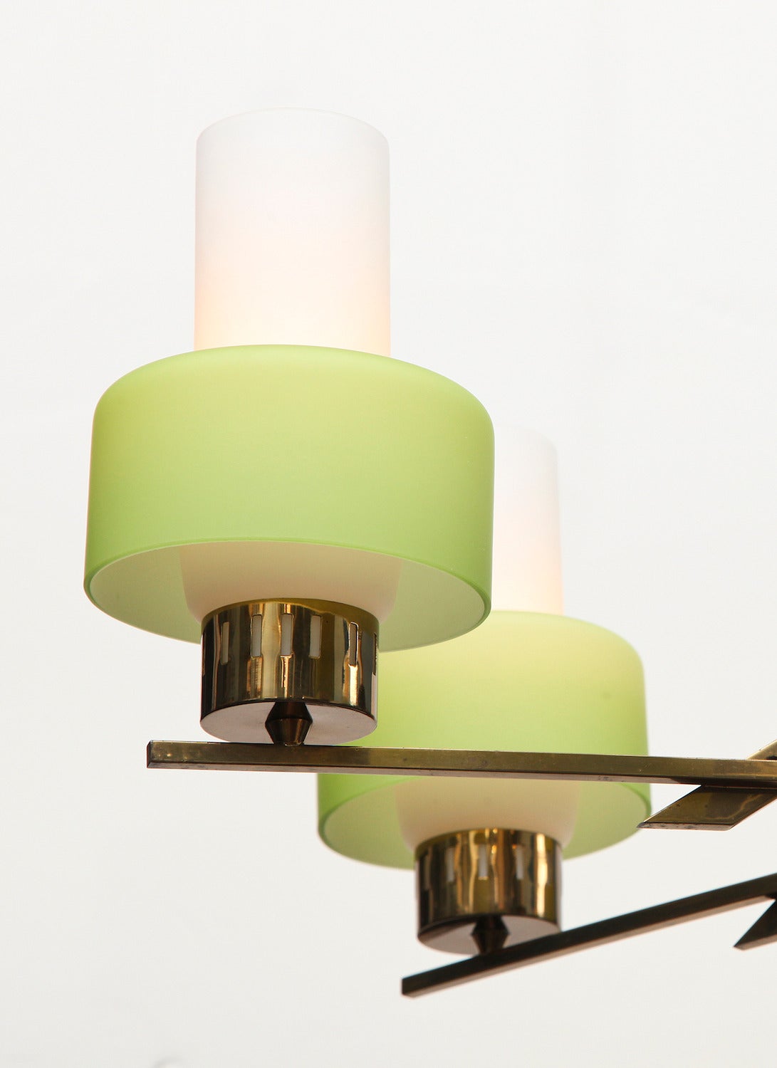 Six-arm ceiling light by Stilnovo.  Polished and black-painted brass structure of graphic form. Each arm with one Edison-sized socket and two-piece white and green, frosted glass shades. An unusual example of mid-1960s design.