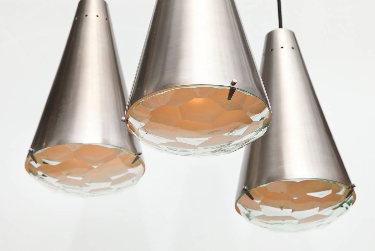 Rare three-cone pendant no. 2126 by Max Ingrand for Fontana Arte.  Beautiful ceiling lamp produced by Fontana Arte and featuring three spun-brass cones in a brushed nickel finish. Each cone conceals one interior Edison socket and is capped by a