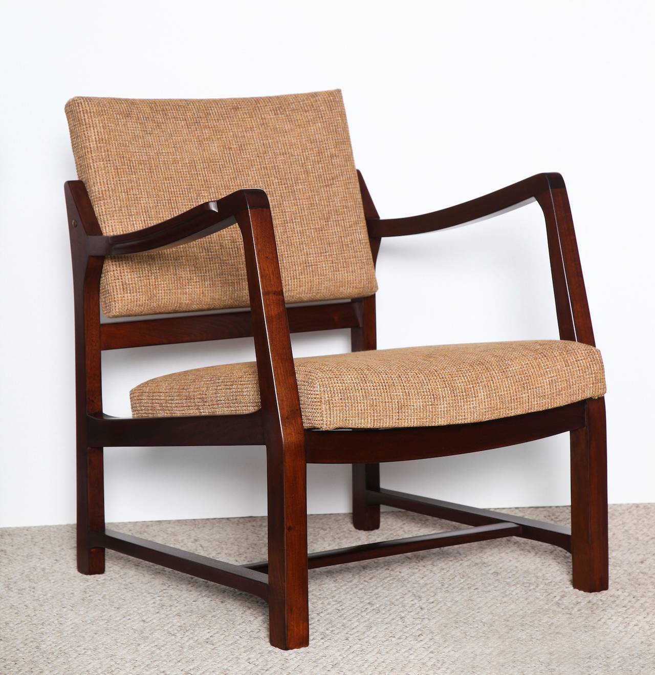 Rare pair of open armchairs by Edward Wormley for Dunbar.  Model #4869B, dark-stained walnut frame with upholstered seat and back. Sculptural form, open-arm design with swivel mechanism on backrest.