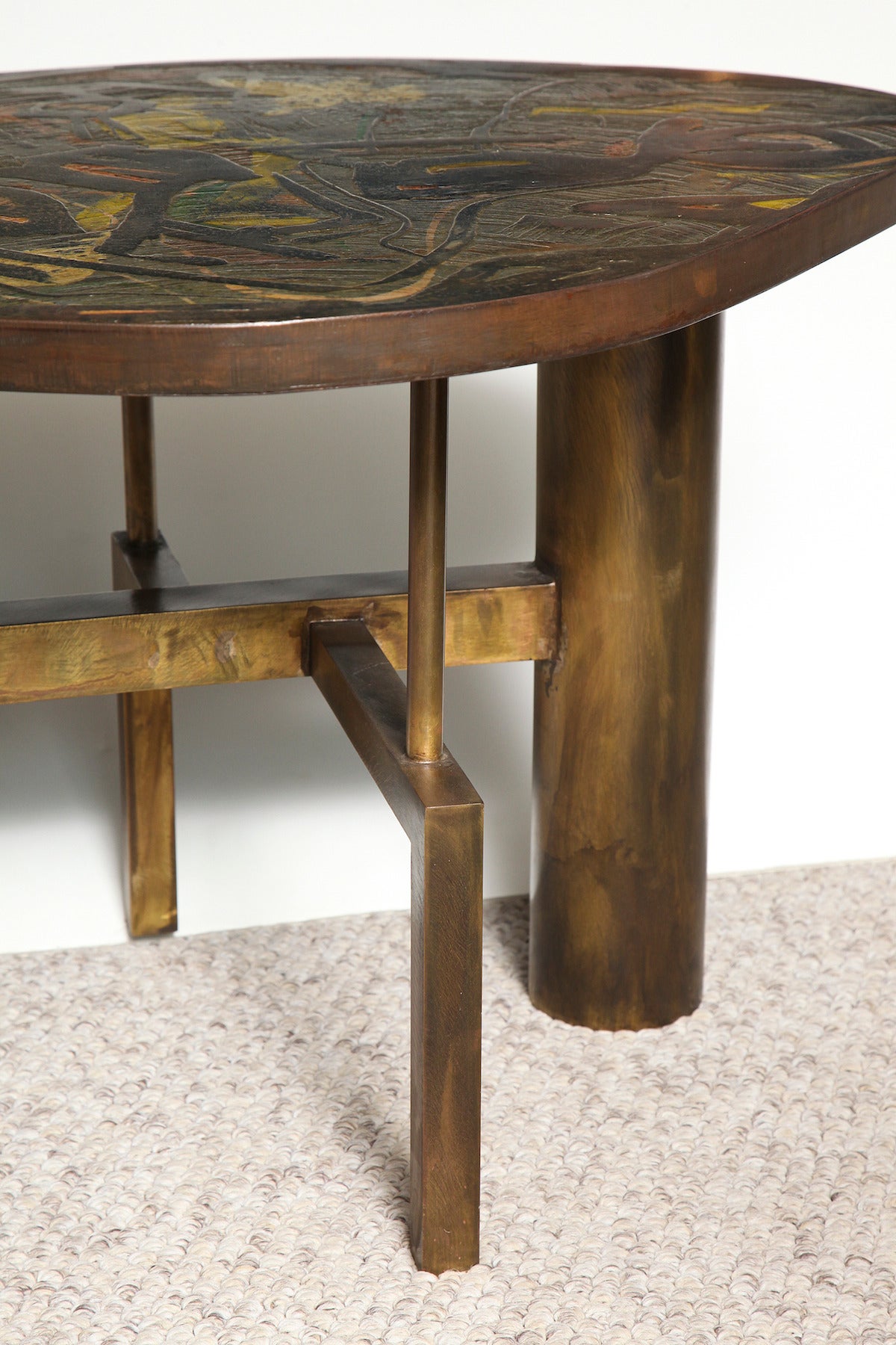 Architectural bronze structure with extraordinary irregular top created in two layers. Bottom layer in pewter with incised lines and splashes of colored enamel, overlaid with sheets of patinated bronze in abstract shapes. This table was created