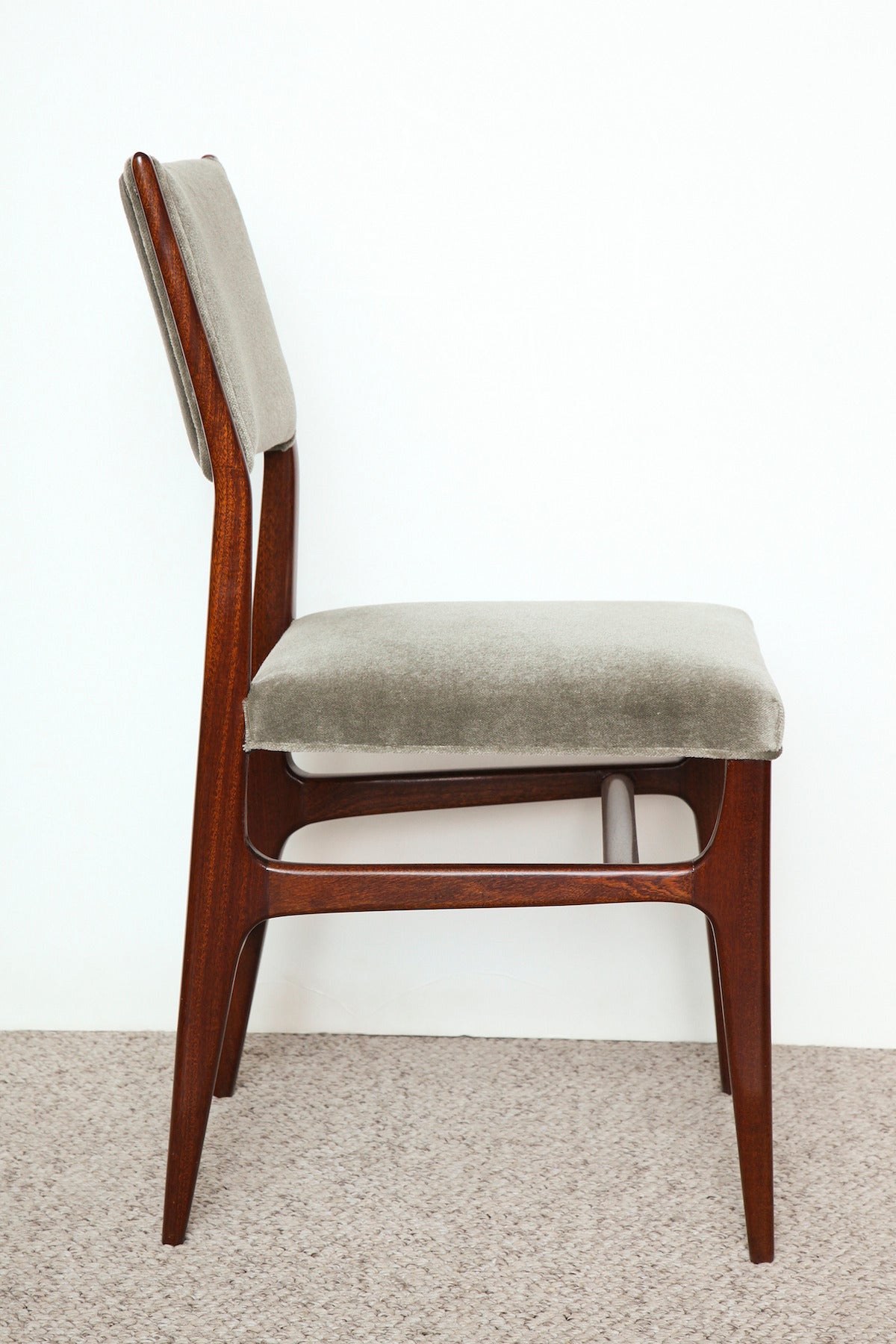 Iconic side chair, with walnut frame, tapering legs, and uphostered seat and back.