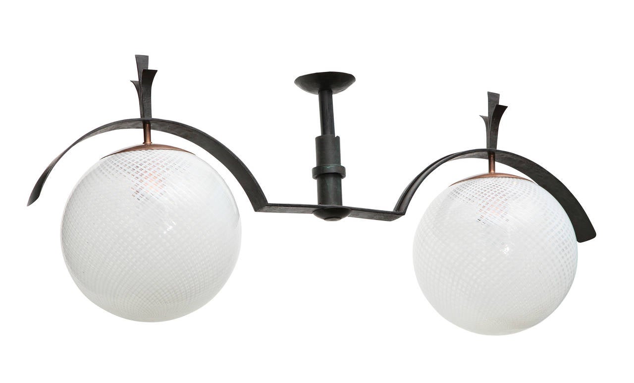 A rare creation by Genoa based architect Labò. Graphic form of dark iron with some copper detailing. Two lights with beautiful, handblown Venini globes.