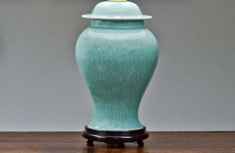 Pair of Celadon Temple Jar Lamps. With a floral design in relief. Shades available separately.
