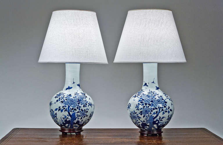 Pair of large blue and white porcelain globe lamps with floral motifs.
*Shades Not Included.