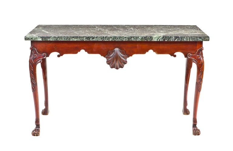 A fine Irish mahogany console table with green Connemara marble top. The scalloped frieze centered by carved shell. Cabriole legs carved with acanthus leaves. Ending in carved carved hock and paw feet. Circa 1770.