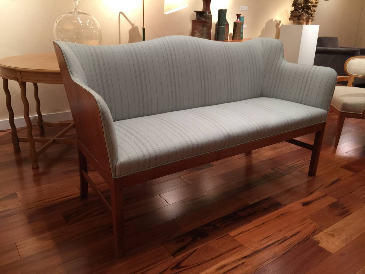 Ole Wanscher (1903-1985).

Rare loveseat by Ole Wanscher for A.J. Iversen, Denmark, circa 1940.
Beautiful mahogany idea and back with new upholstery. 

Dimensions: 60” W x 24.5” D x 33.5” H.