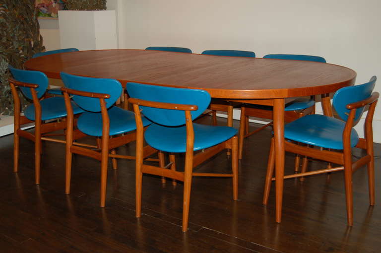 Finn Juhl Dining table + eight chairs
Teak with leather upholstery
Niels Vodder, cabinetmaker
Copenhagen, Denmark 1953,Makers mark to underside

Table: Fully extended. 93