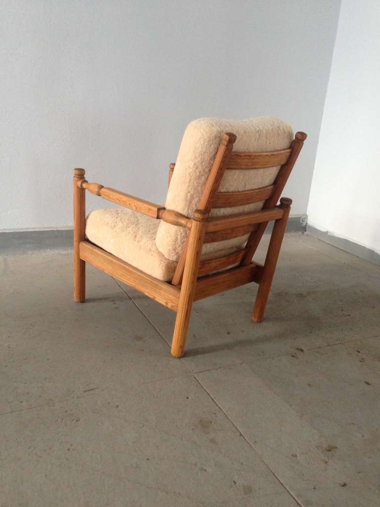 Rare lounge Chair by Axel Einar Hjorth from the Sandhamn series for NK, Sweden 1929. Carved pine with cushions covered in shearling.