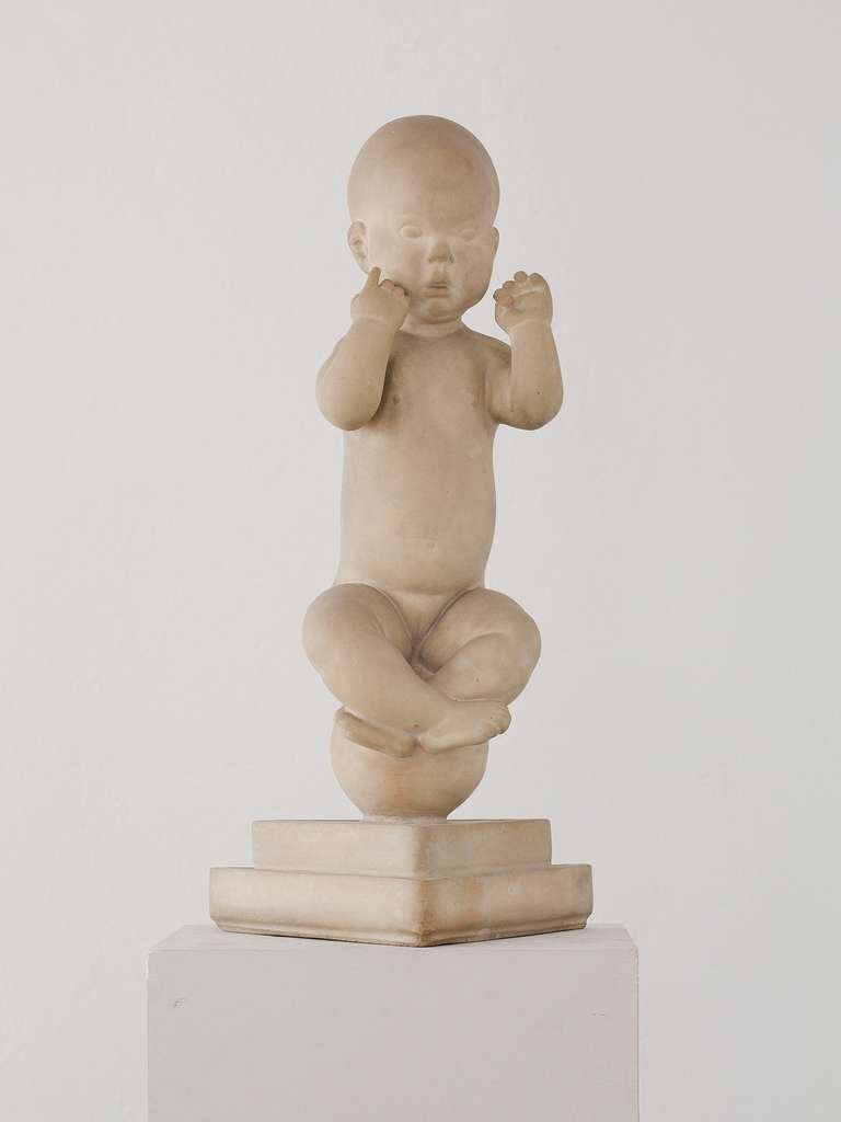 Unglazed terracotta figure of a baby seated on a sphere.
Denmark, ca.1950.

easures: 31.5