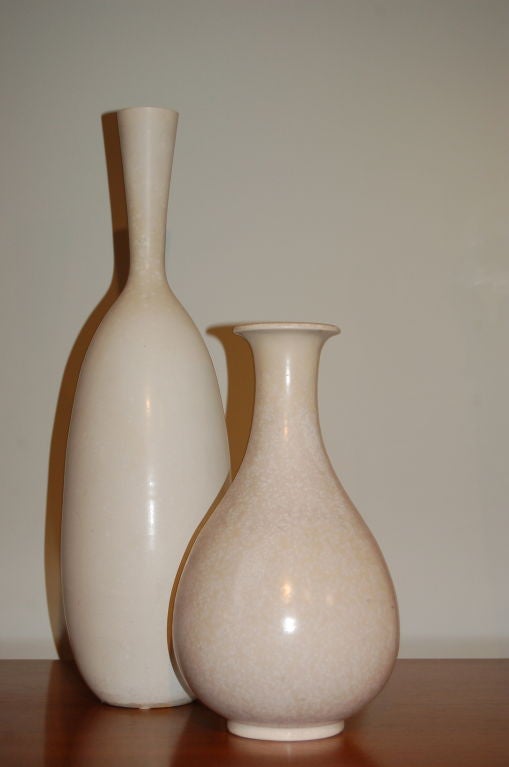 2 vases by Carl Harry Stalhane and Gunnar Nylund in creme eggshell glazes. <br />
Beautiful modernist forms measuring 21