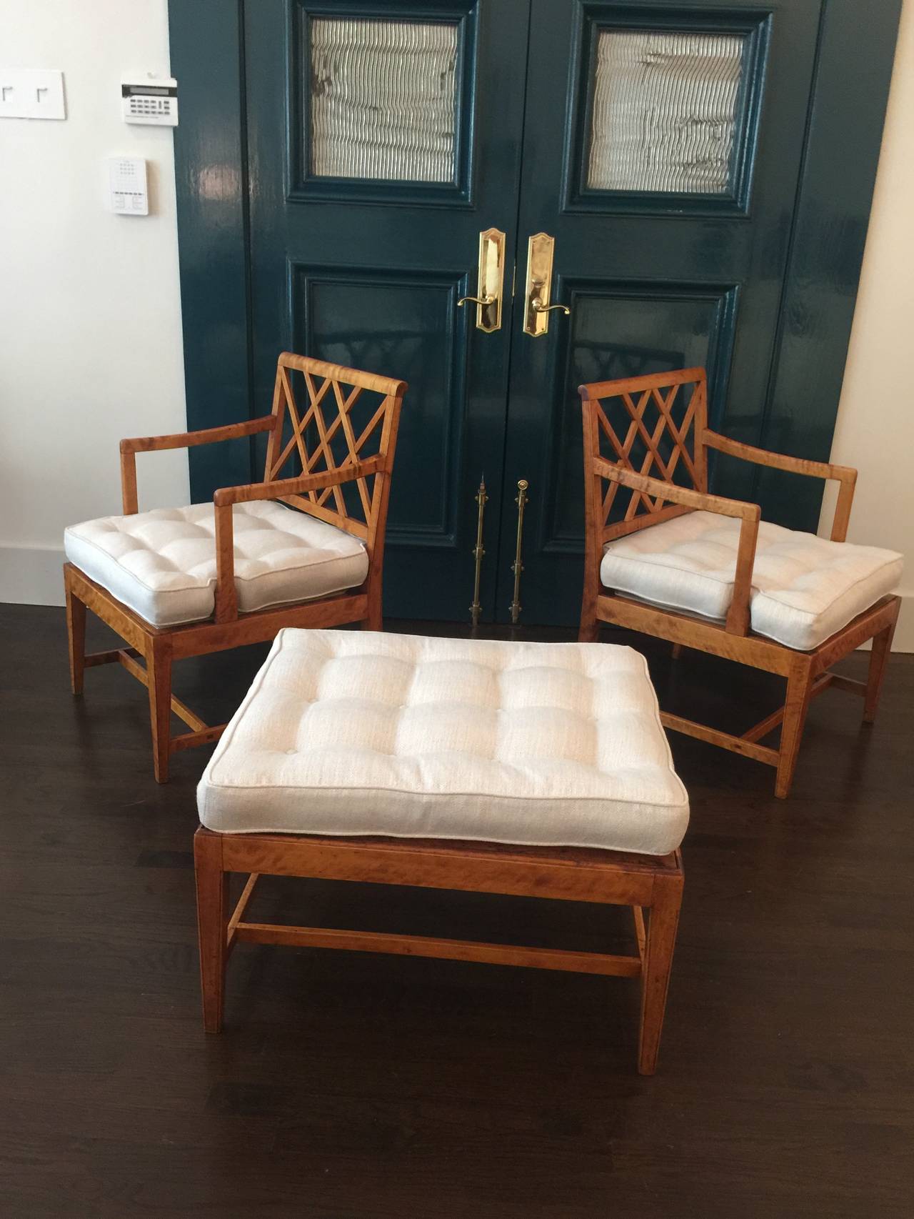 Beautiful pair of armchairs and ottoman in flamed birch by Swedish master, Carl Malmsten. Newly upholstered cushions and light restoration to the wood. These chairs are beautiful examples of early Swedish refined cabinetmaker work.

Chairs: 22.5