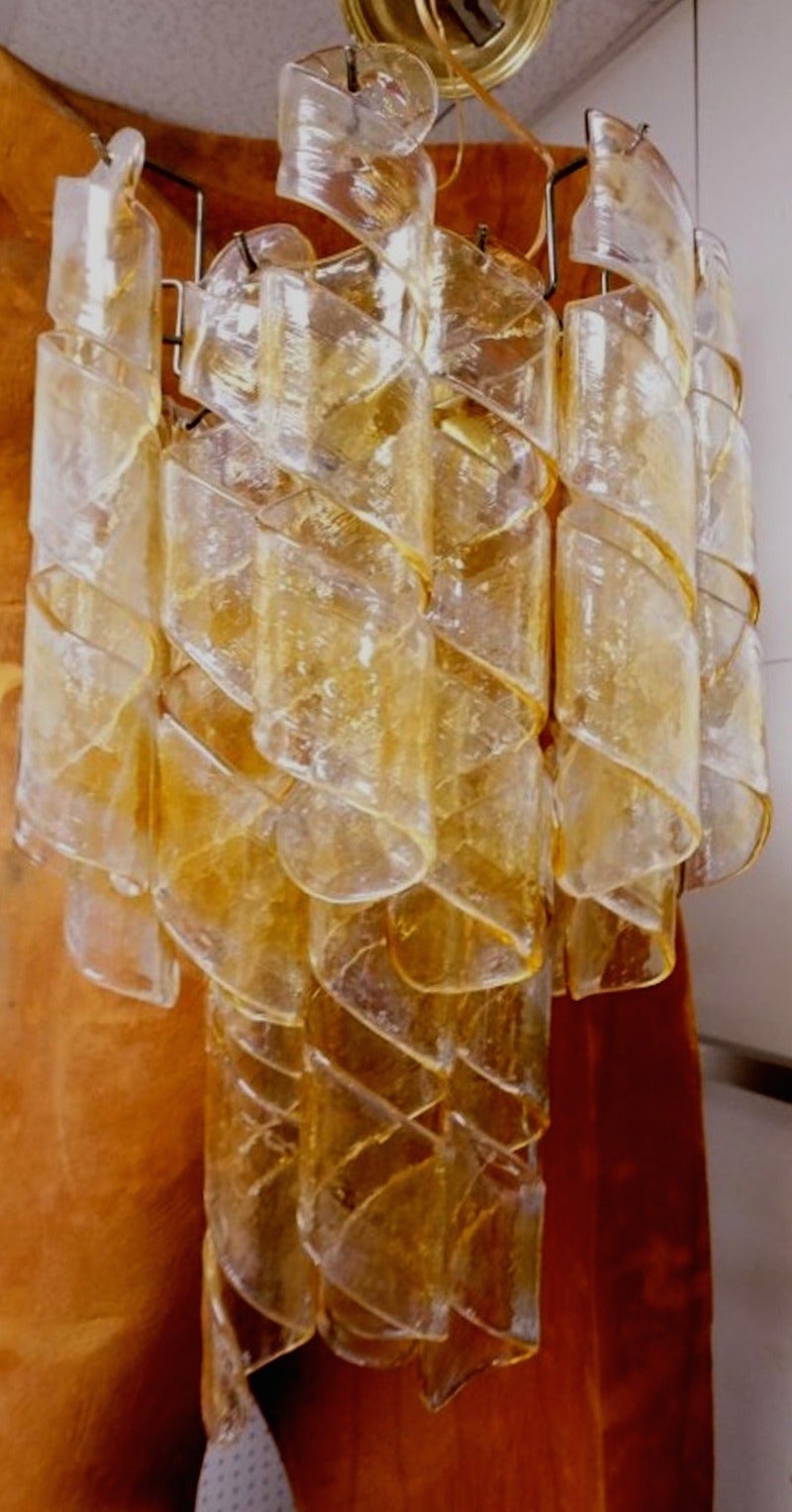 A wonderful Mazzega confection in amber and clear curlicue glass. There are several extra pieces that will accompany should they ever be required.