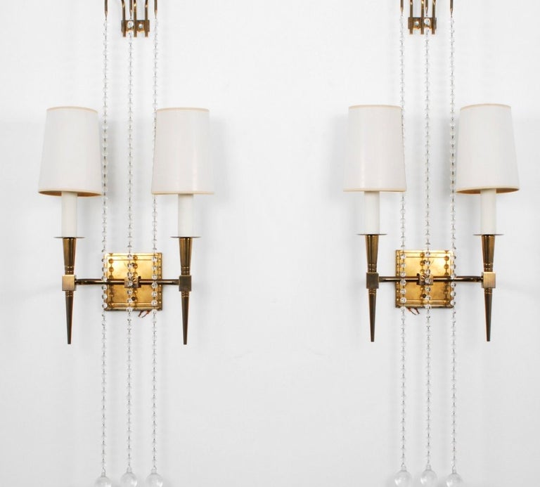 A truly stunning of brass two-light wall sconces with etched starburst motif and draped with three strands of glass beads. Parzinger at his best !