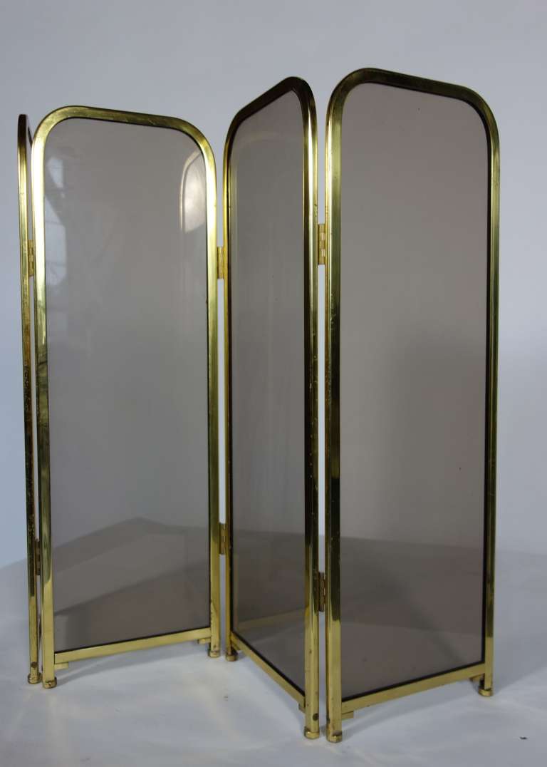 A straightforwardly designed glass and brass four panel folding fireplace screen.

Width listed in dimensions reflect the width as shown in image #1.