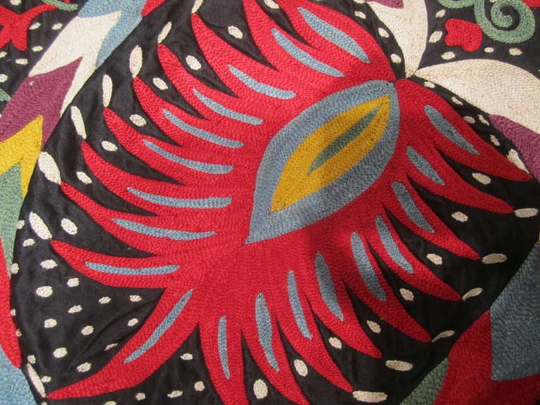 This amazing textile shows off the best embroidery skills of the Uzbek village women who make these as dowry pieces. This particular example is a wedding bed cover size. The deep silk ground cloth sets off the vibrant silk embroidery. The scale and