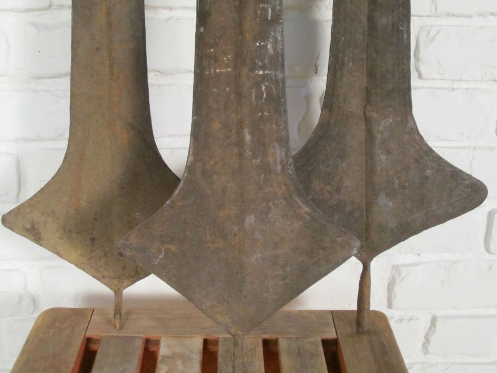 These forged iron blades, also referred to as doa or ngbele, were used for barter (on occasion for brides), not as the weapons they appear to be. This collection of 3 are in excellent condition and are beautifully sculptural reminders of old world