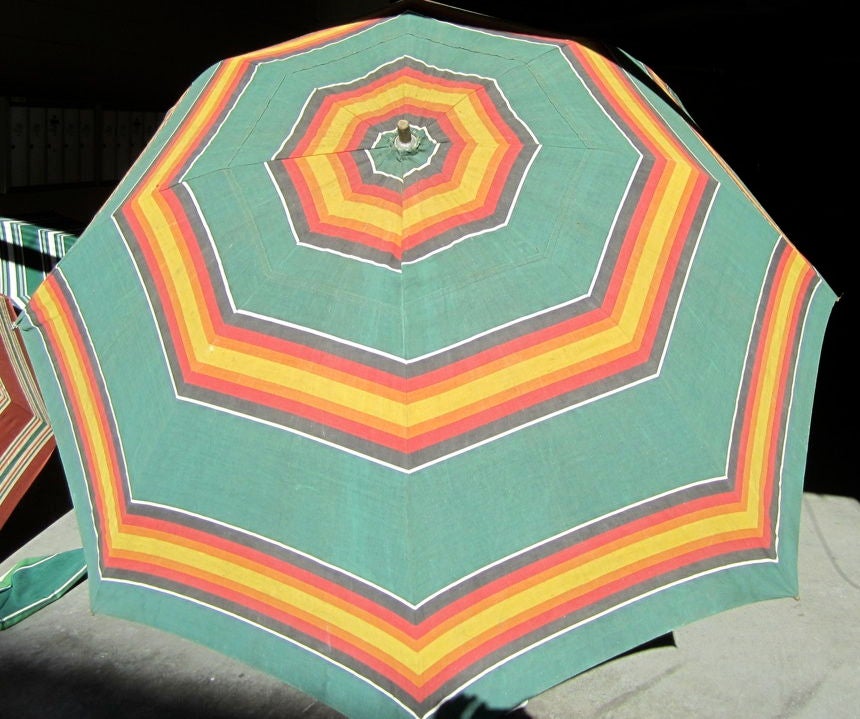 Super fun vintage beach umbrella. I currently have nine available in an assortment of colors. You'll be the coolest cat at the beach !