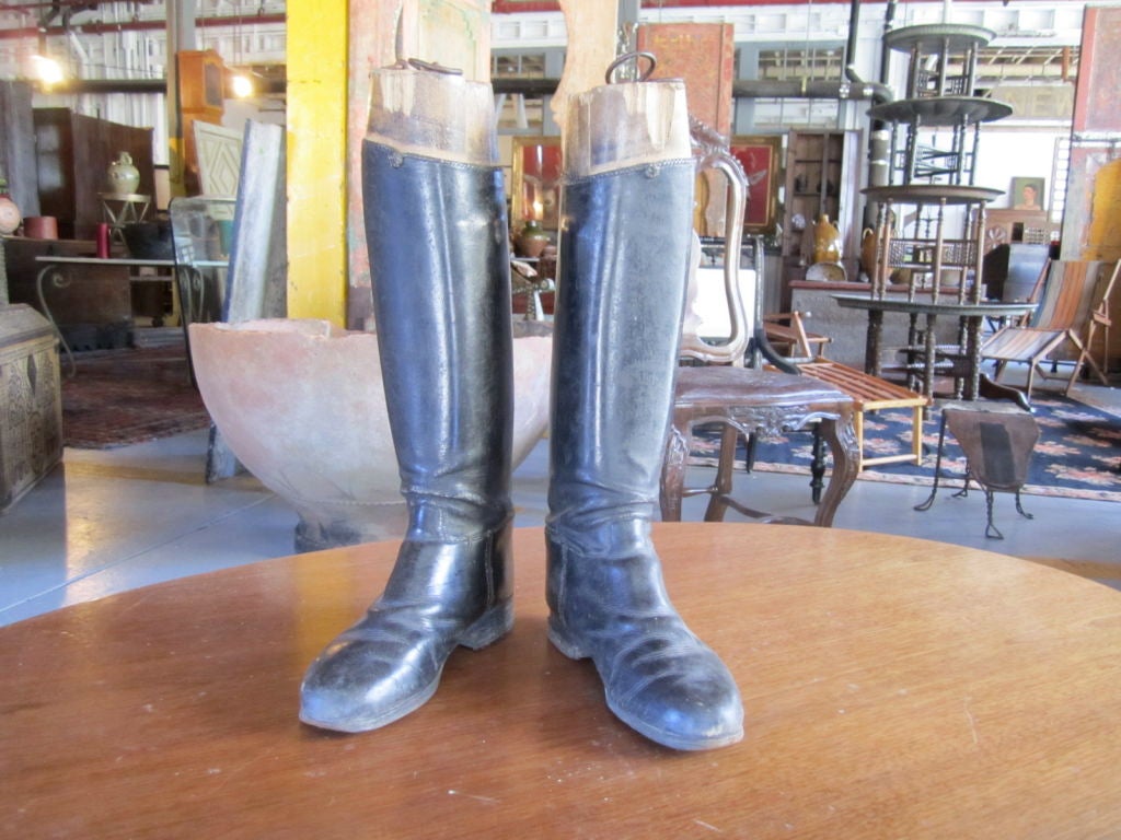 Stately pair of English riding boots with wooden forms.