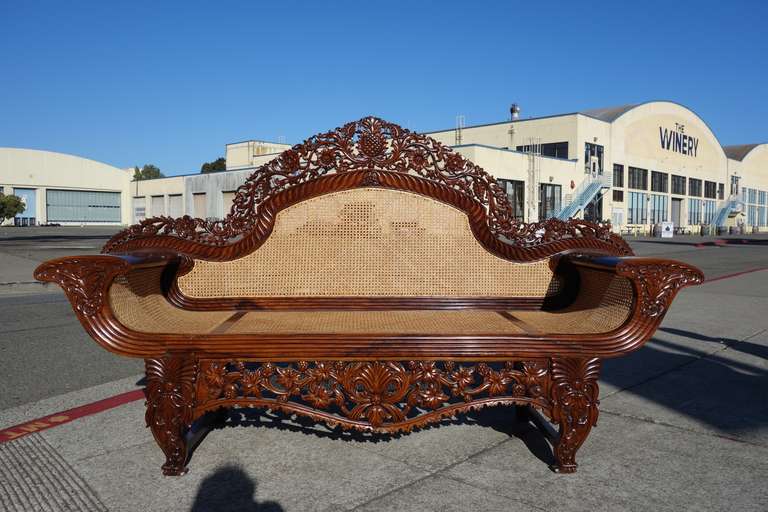 Late William IV carved rosewood British Colonial sofa, with intricate openwork carved back surround, canted pillow form ends, openwork front pendant unit, set on carved legs.