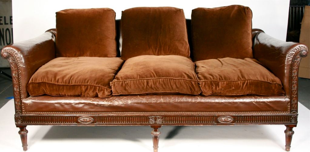 Wonderfully carved frame and leather library sofa. I have two club chairs that match.