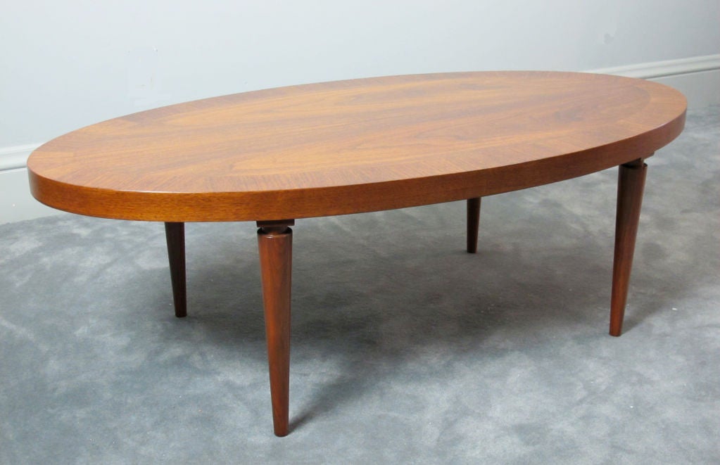 Beautiful walnut Widdicomb oval coffee or cocktail table designed by Robsjohn-Gibbings. Labeled on underside of table and stamped with style number and date. A very elegant Gibbings design.