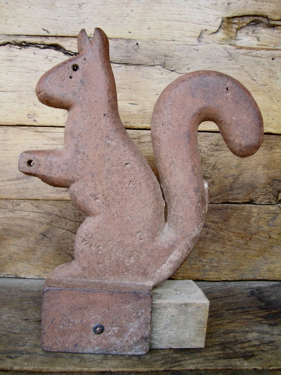 An incredible early 20th century cast iron windmill weight in the form of a squirrel.