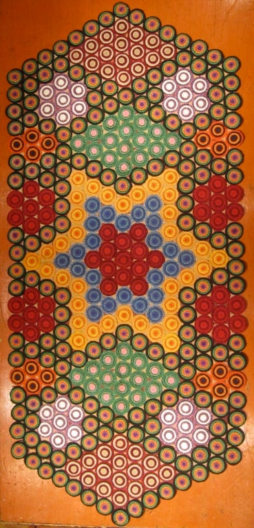 This is a knock your socks off 1920s multi color penny rug. Tucked away for years, it has retained it's glorious color.