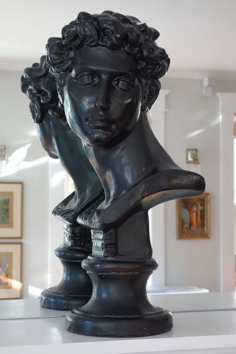An unusual and regal bust depicting David in solid, painted plaster.