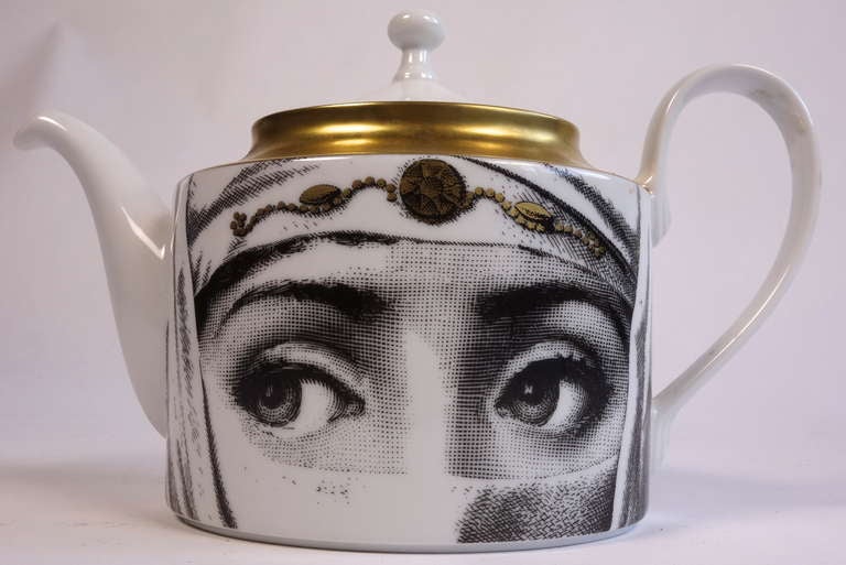 An original circa 1999 Fornasetti for Rosenthal teapot. Comes in its original box and has never been used. For the stylish tea drinker who doesn't mind a pair of eyes glancing at her.