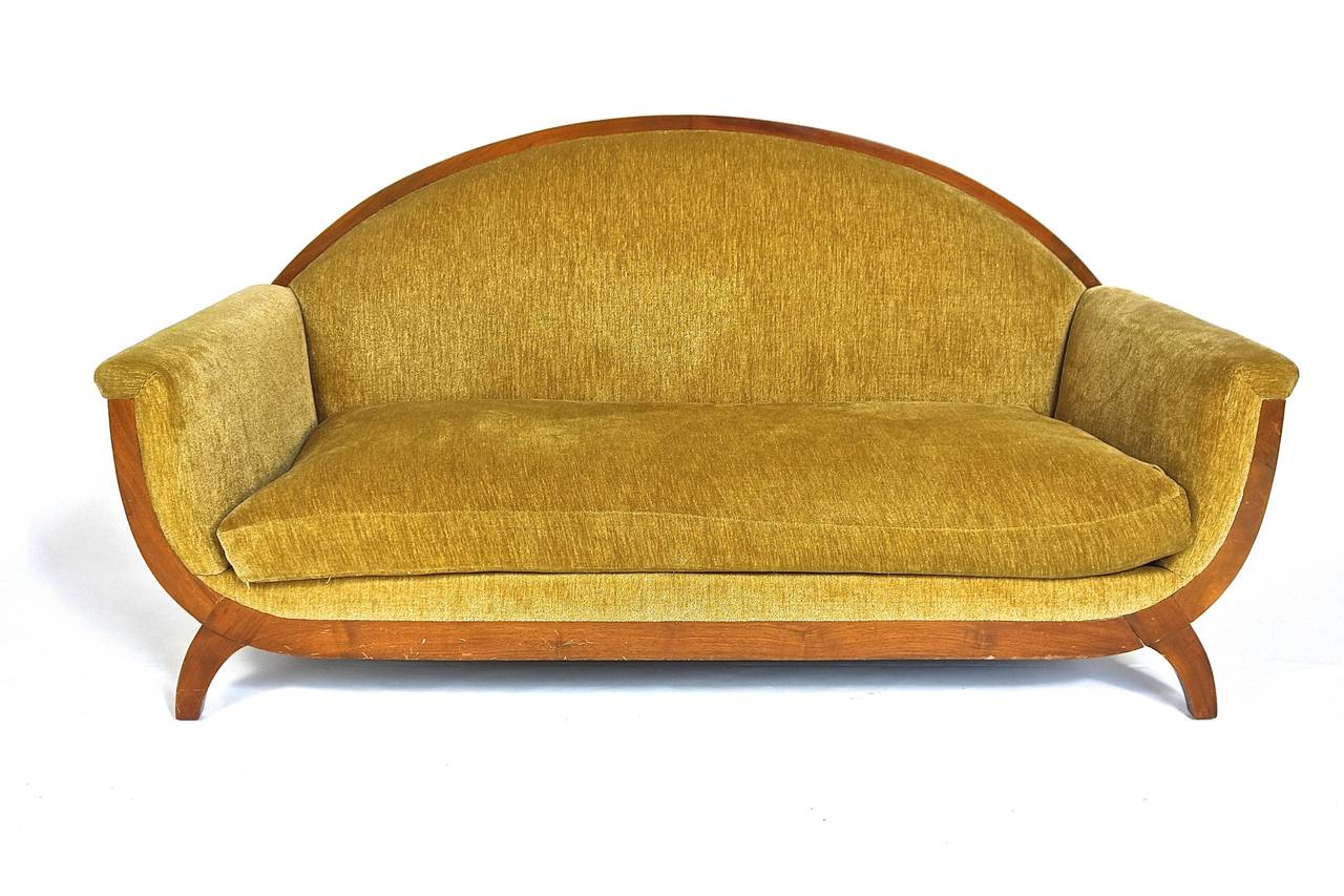 An exceedingly rare salon suite comprised of a sofa and two tub back chairs each with a low, arched back. The seats sit on dipped rails and lateral C-scroll legs. The suite is by renowned Art Deco furniture maker, Lucie Renaudot. 

Provenance: