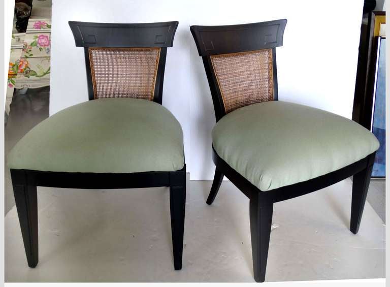 A fantastic pair of chairs in the asian modern design.
Beautifully styled with a pagoda style back which is highlighted by a Greek key shaped trim.
Chairs have been finished in a rich combination of espresso stained wood and naturally darkened