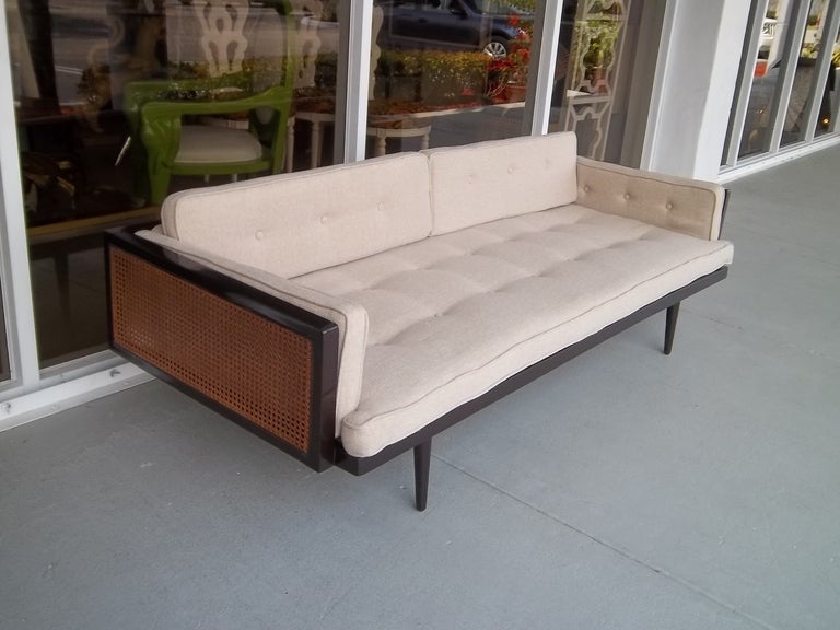 A midcentury sofa having a fantastic combination of reed and a newly finished expresso lacquered finish.
Clean low straightlines give this piece a modern yet classical look.
Newly finished .