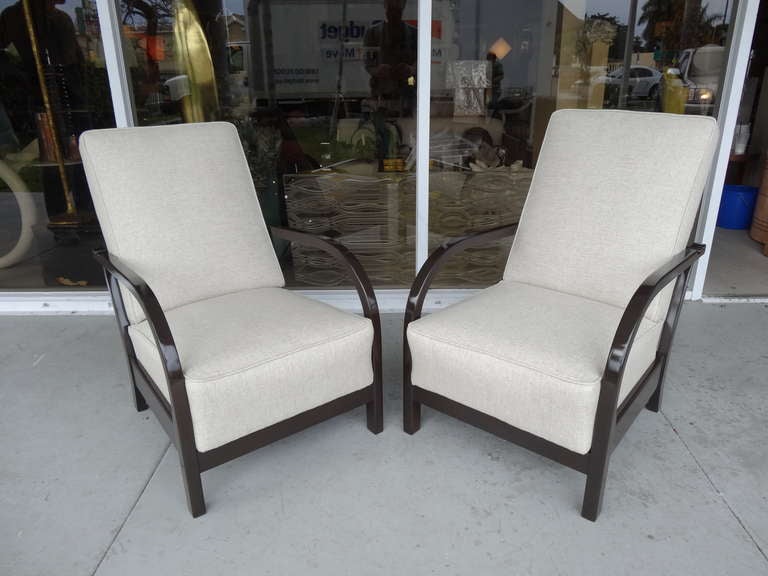 Pair of french art deco club chairs circa 1930's. 
Chairs have simple and graceful lines which are complimented by the 
new expresso lacquered finish and oatmeal upholstery.
The new finish gives the pair a modern fresh look.
Interesting design