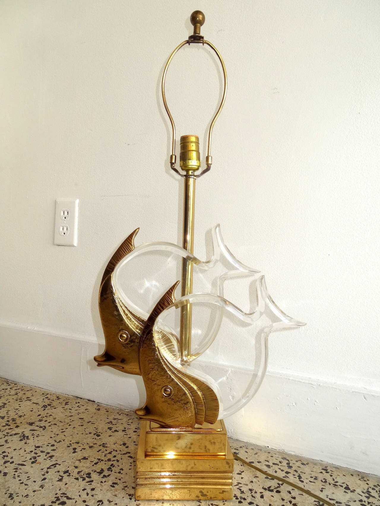 A brass and Lucite lamp having a pair of fish mounted in Lucite. The lamp has great scale and attention to detail. First quality. Possibly Italian. Height to the top of the fish is 17
