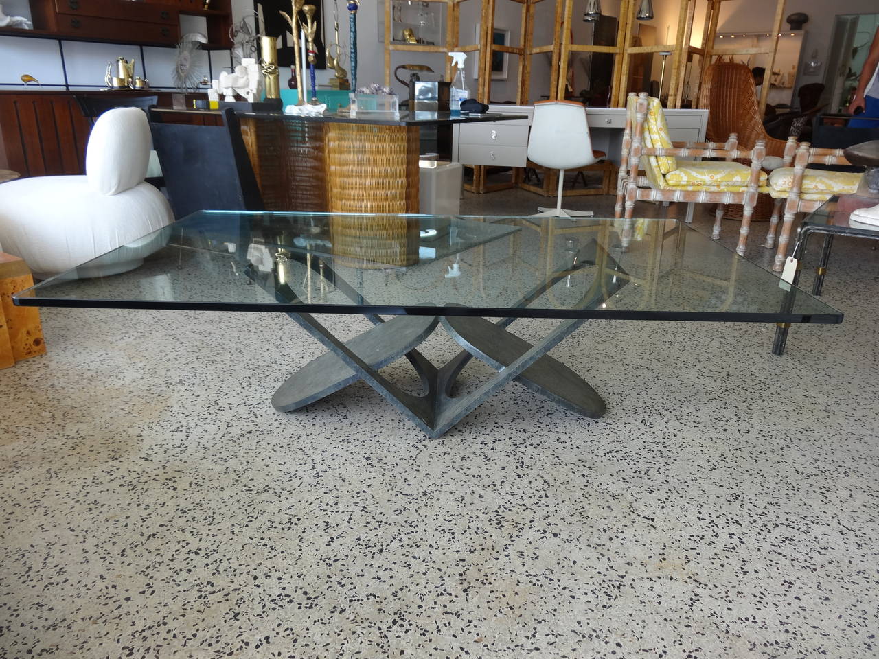 A most unusually formed coffee table of ovals and open rectangles. Love the way the different shapes and open spaces work to form this table. This piece has a geometric/abstract form which is complimented by the bronzed colored finish. Glass has the