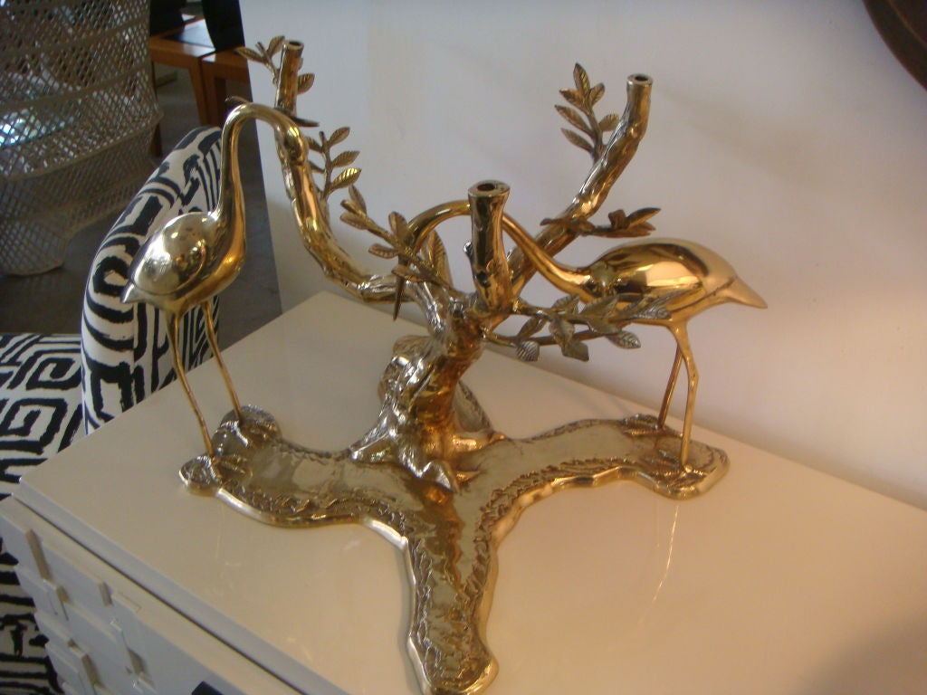 A fantastic coffee table base of brass in the form of a tree with cranes.