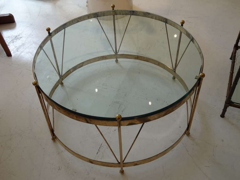 Beautiful drum shaped coffee table . The frame is solid brass. The glass has couple chips that are shown in a picture. Sold as is.