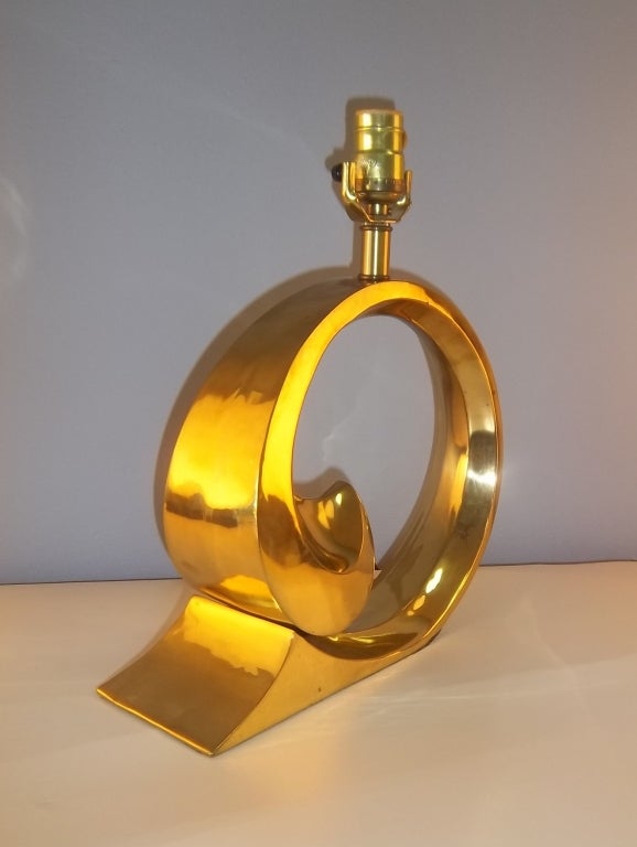 A pair of brass lamps in the manner of Pierre Cardin. beautiful and elegant scrolling design. Elegant and Modern.