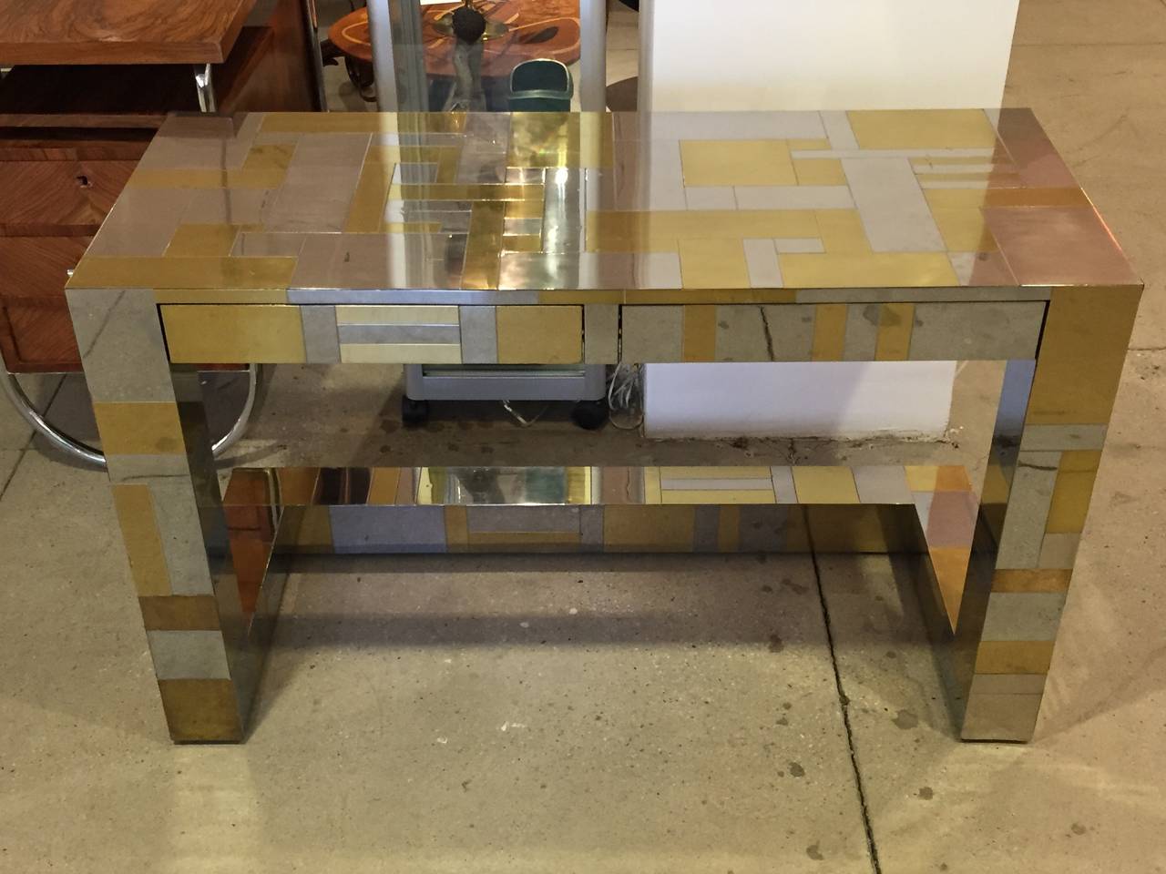Beautiful brass and steel cityscape desk by Paul Evans. Desk has two drawers. Piece is signed. Has some wear.