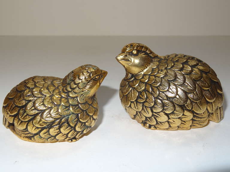 A pair of bronzed qual formed salt and pepper shakers by Gucci.