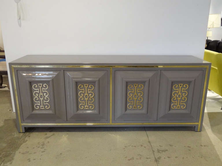 Great lacquered Mastercraft credenza with four door . Has beautiful brass details in the doors. Refinished.