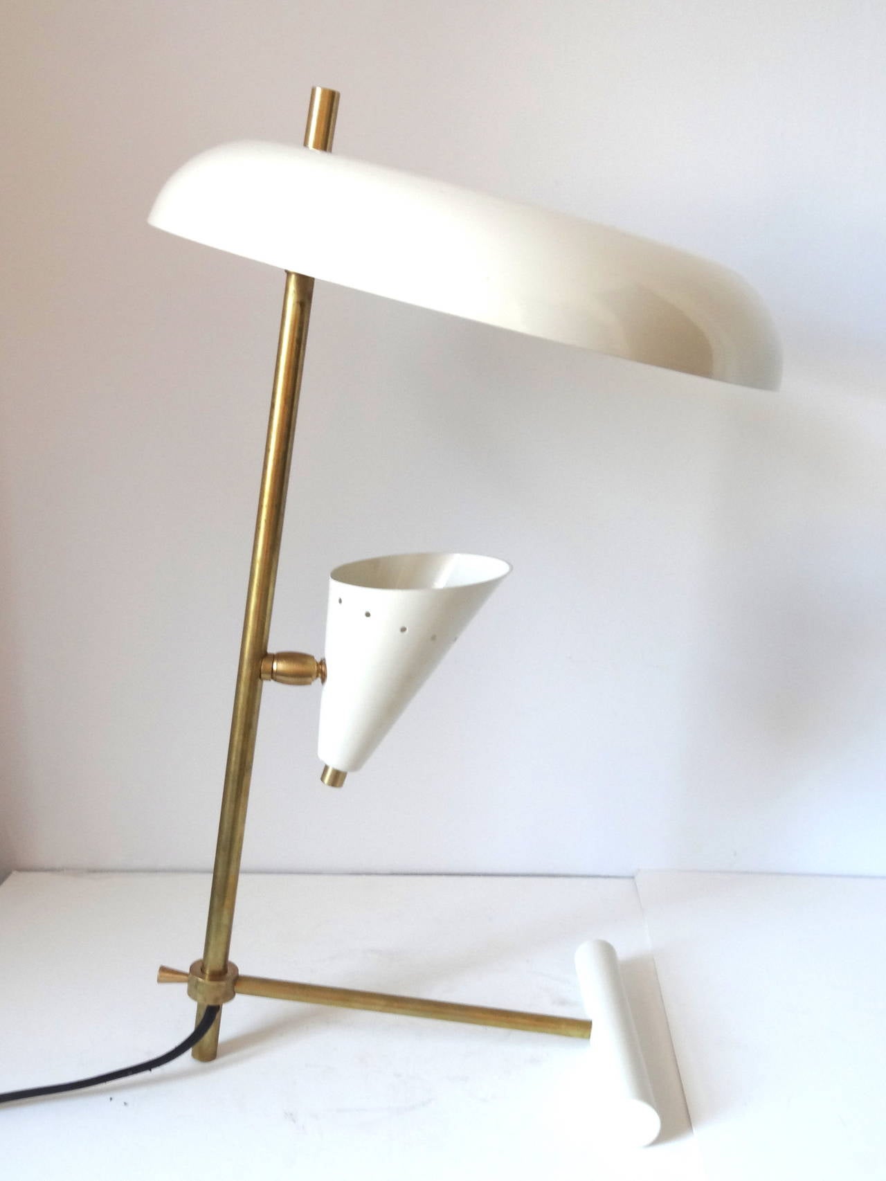 Pair of Italian brass table lamps in a style of Stilnovo. Unusual counter weight with lacquered metal shades. Rewired.