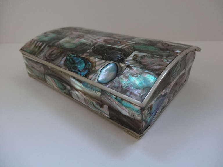 A beautiful slightly domed box of abalone shell and trimmed in silverplated metal.
Stamped Mexico. Apalca