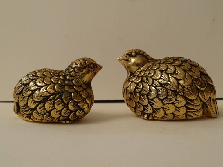 A pair of gold washed salt and pepper shakers in the form of a qual. Beautiful details.